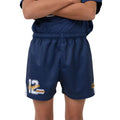 A close-up of a person wearing navy blue footy shorts with a white and yellow number 12 graphic on the left leg and a small circular logo on the right leg, paired with a matching navy top against a white background.