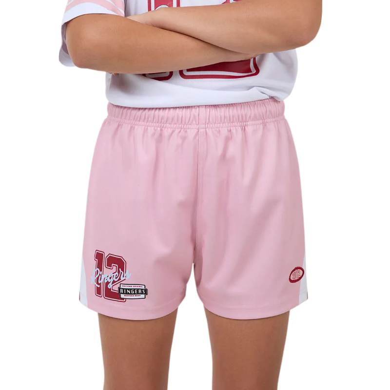 A child wearing light pink athletic shorts with a white and red sports jersey partially visible, photographed against a plain white background.