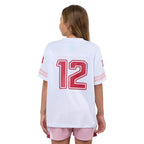 Girl wearing a white sports jersey with red numbers on a white background