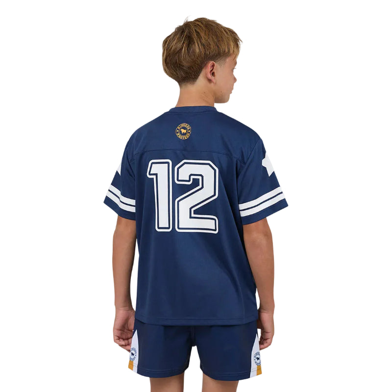Child wearing a navy blue sports jersey with number 12 on a plain background