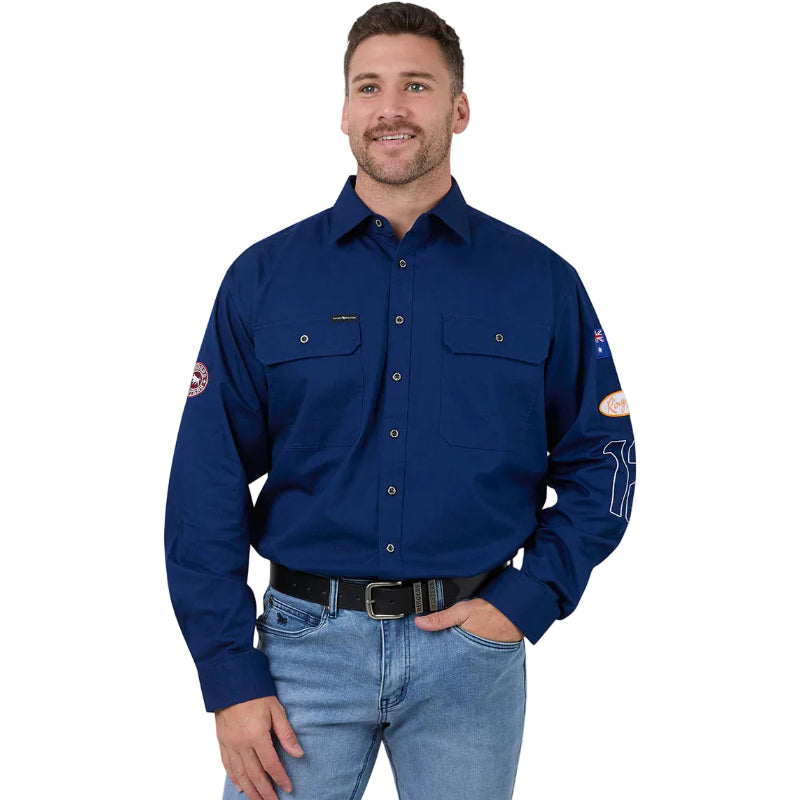 Man wearing a blue work shirt with patches on a white background