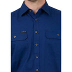 Close-up of a blue button-up shirt with a brand logo on a white background