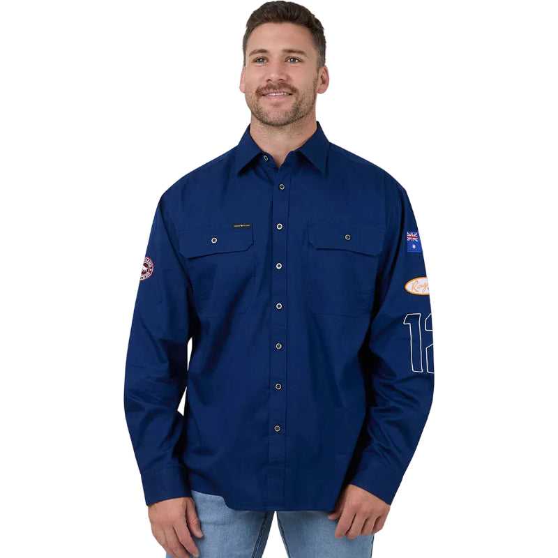 Man wearing a blue work shirt with patches on a white background