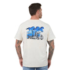 A man viewed from the back wearing a cream-coloured t-shirt with a large graphic print on the back. The graphic features three blue horses in silhouette above a blue and white semi-truck with 'Ringers Western' written on the side.