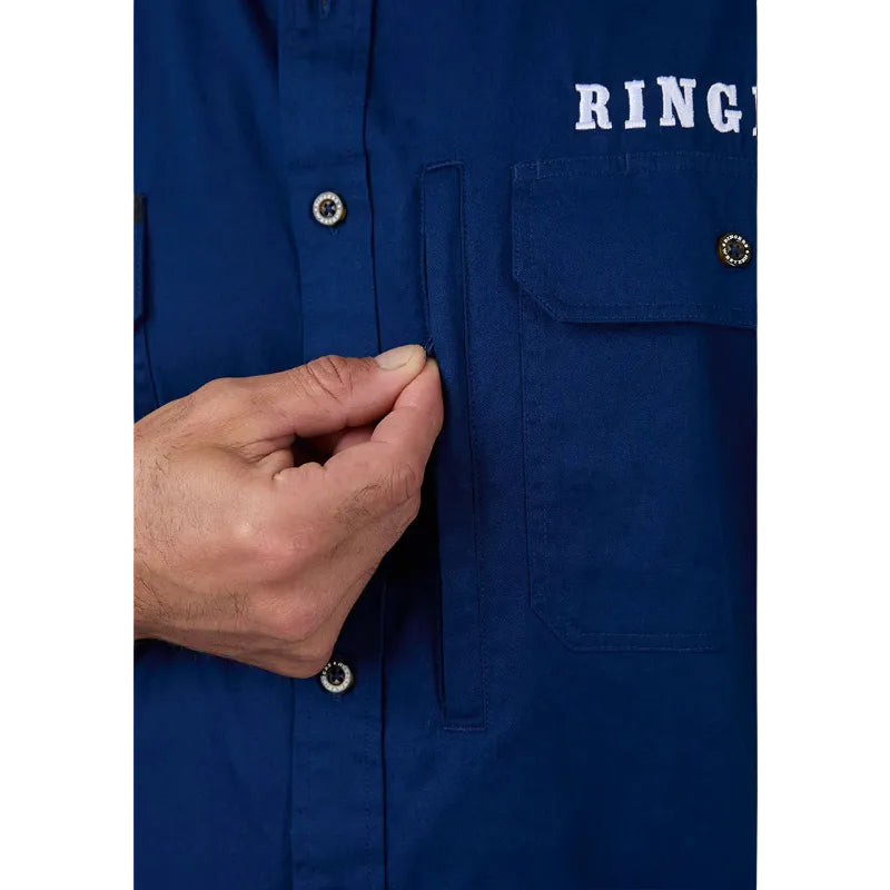 Close-up of a blue button-front shirt with a hand pulling a pocket flap, showing a white RING logo on the chest.
