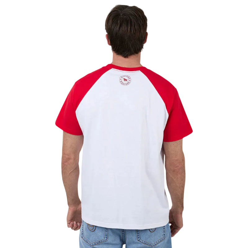 A man viewed from behind wearing a raglan-style t-shirt with a white body and red sleeves, paired with blue jeans, against a white background.