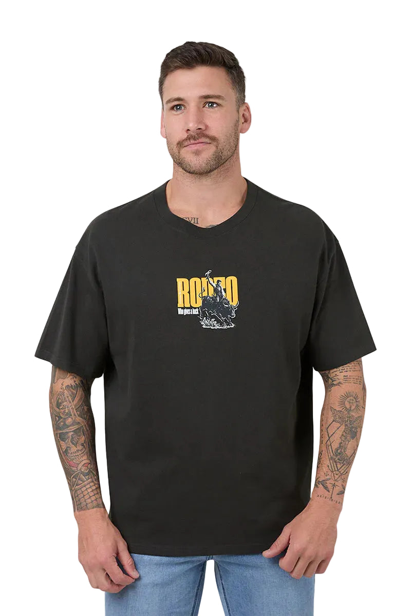A man wearing a black short-sleeve t-shirt with a yellow and white graphic on the chest, paired with blue jeans, against a white background.