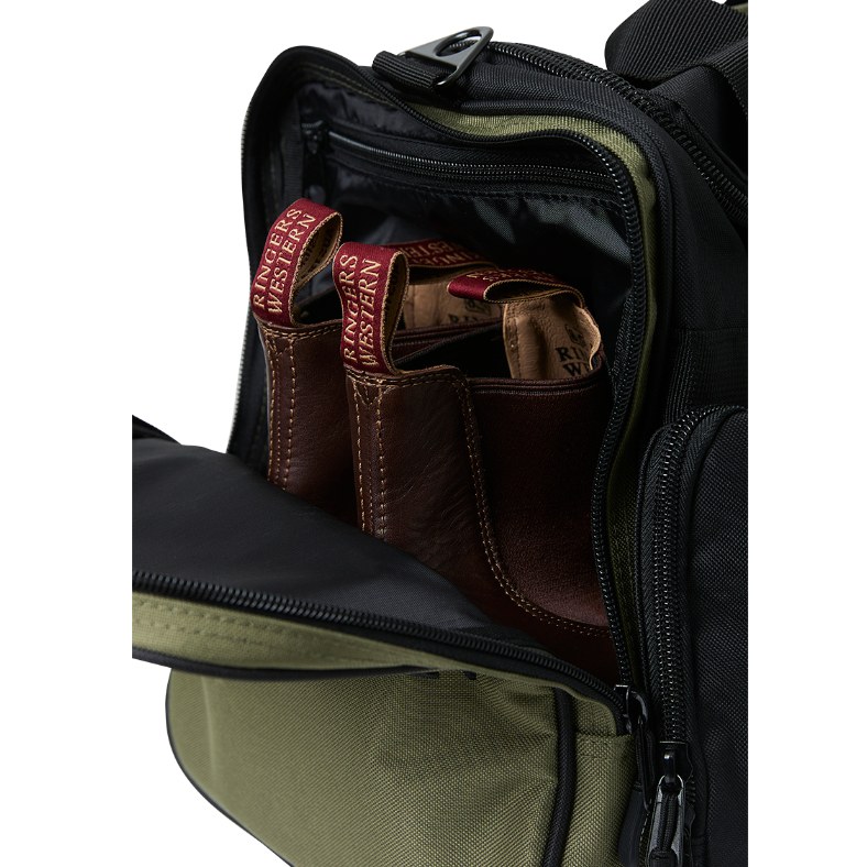 A black and army Ringers Western Rider Go Sports Bag (625130RW) duffel bag with 'Ringers' branding, featuring a top carry handle and showing the zipped end compartment with a pair of brown chelsea boots in it.