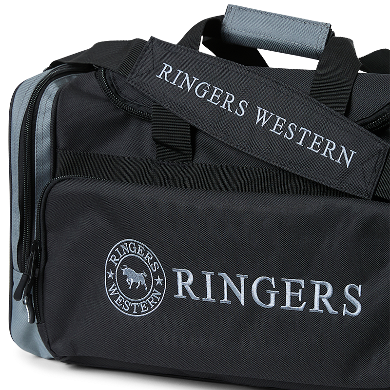 A black and charcoal Ringers Western Rider Go Sports Bag (625130RW) duffel bag with 'RINGERS' printed in charcoal on the front and 'RINGERS WESTERN' on the side, shown on a plain white background.