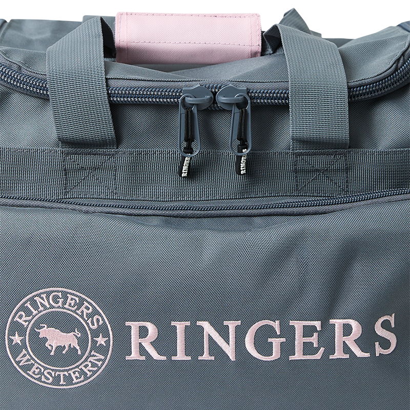 A close up of a Ringers Western Rider Go Sports Bag (625130RW) duffel bag in charcoal and pastel pink, featuring the brand logo on the front, showing carry handle and zip detail on a white background.