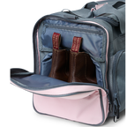 A charcoal and pastel pink Ringers Western Rider Go Sports Bag (625130RW) duffel bag with 'Ringers' branding, featuring a top carry handle and showing the zipped end compartment with a pair of brown chelsea boots in it.