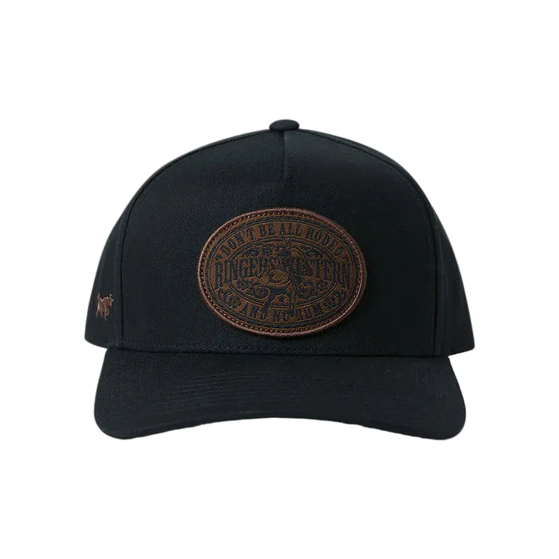 A black baseball cap featuring a prominent brown circular leather patch on the front with a small embroidered logo on the side, set against a white background.