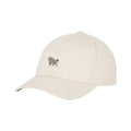 A light beige baseball cap with a small embroidered black bull logo on the front, set against a solid white background.