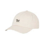 A light beige baseball cap with a small embroidered black bull logo on the front, set against a solid white background.