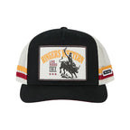 A black trucker hat with white mesh side panels, featuring a rectangular front patch with a cowboy riding a bucking bull and the text 'Ringers Western Live Rodeo 2012'. The brim and top of the cap are black, and the side panels have white mesh with red and yellow stripes.