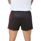 charcoal grey footy shorts with red side stripes and a red circular logo on the left leg, shown on a model from the back wearing a white t-shirt.