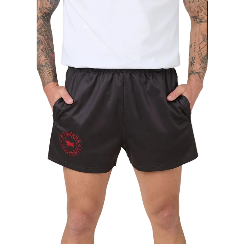 charcoal grey footy shorts with a red circular logo on the left leg, worn by a model with a white t-shirt against a white background.