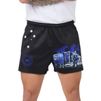 Black footy shorts with a blue and white semi-truck graphic and white star details, shown on a model wearing a white t-shirt against a white background.