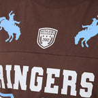 Brown sports jersey with blue graphics and text, featuring a logo and text on a close-up view.