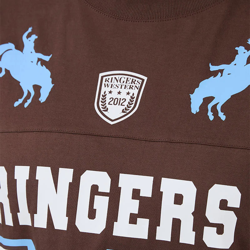 Brown sports jersey with blue graphics and text, featuring a logo and text on a close-up view.