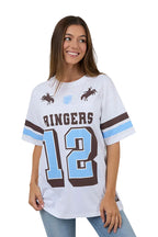 Woman wearing a white sports jersey with 'Ringers' and number '12' on a plain background