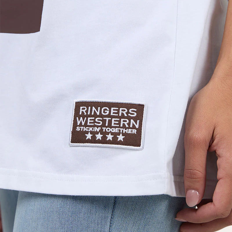 Close-up of a white shirt with a 'Ringers Western' patch on a plain background