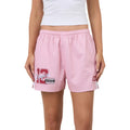 Pink footy shorts with a white crop top worn by a model, featuring a red and white number 12 graphic and 'Ringers' text on the left leg.
