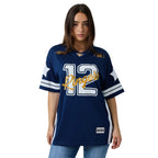 A woman modeling a navy blue short-sleeve sports jersey with white and gold accents. The jersey features the number 12 on the front, 'Ringers' written in gold script across the chest, and sleeve stripes.