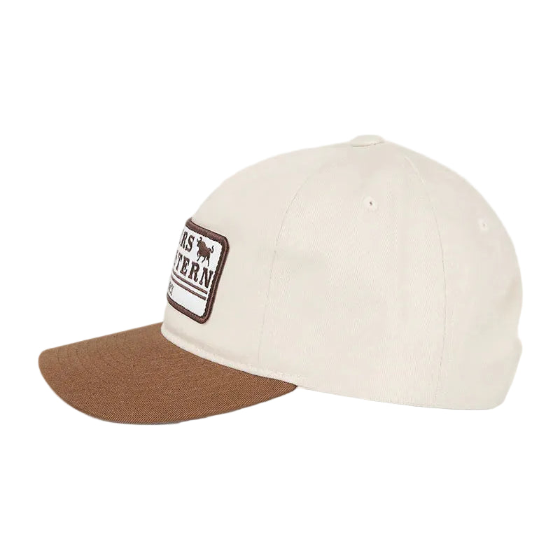 An off-white baseball cap with a brown visor and a rectangular patch on the front.