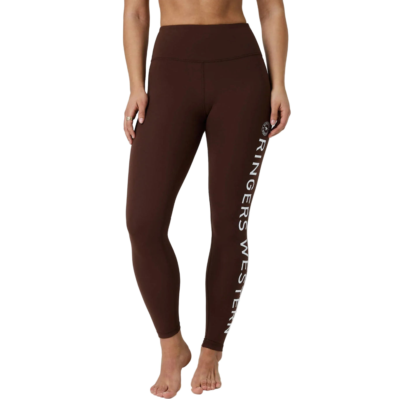 A model wearing high-waisted brown leggings with 'Ringers Western' printed vertically in white on the left leg, shown against a white studio background.