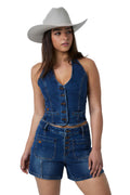 A woman modeling a blue denim two-piece set consisting of a sleeveless button-front crop top and matching shorts, paired with a light beige cowboy hat against a white studio background.