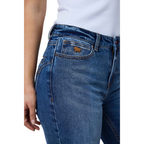 Close-up of a person wearing blue denim jeans with a white ribbed top, showing the front pocket and waistband area against a plain white background.