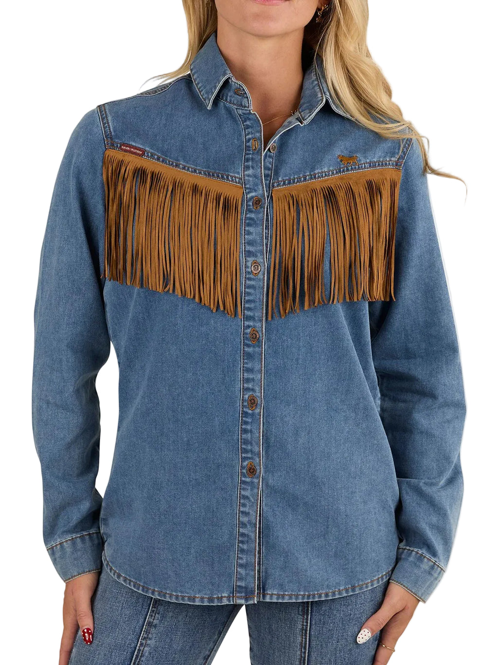 A woman wearing a blue denim western-style button-up shirt with large brown fringe panels across the chest, paired with blue jeans against a plain white background.