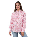 Woman wearing a pink patterned shirt on a white background