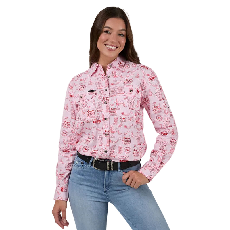 A woman modeling a pink long-sleeve western-style button-up shirt with a red lip print pattern, paired with blue jeans and a black belt, against a white studio background.