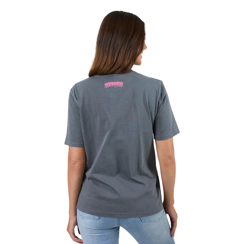 Person wearing a washed black t-shirt with text on the back, standing against a plain background