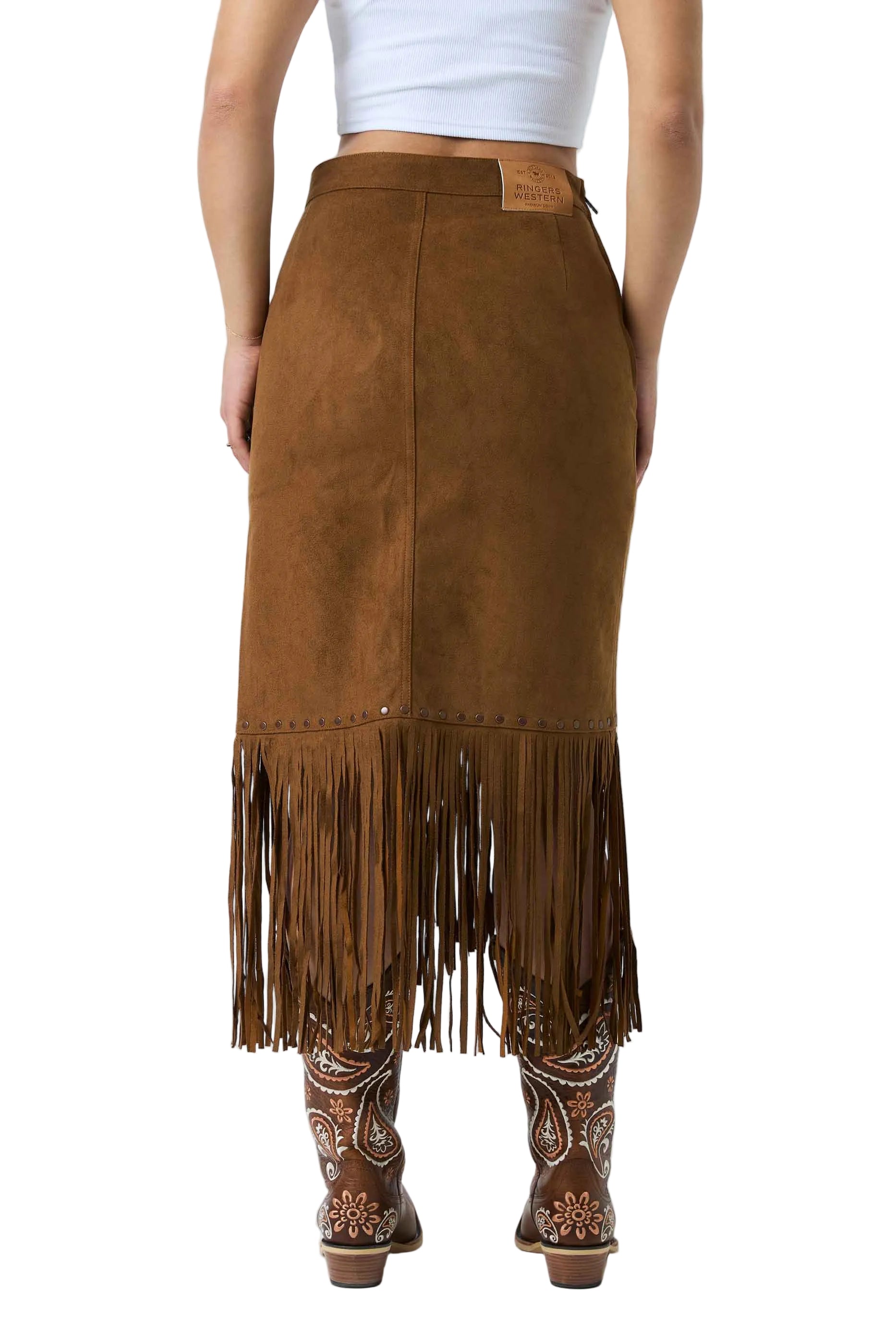 A brown suede fringe midi skirt shown from the back on a model, paired with a white crop top and brown western boots against a white studio background.