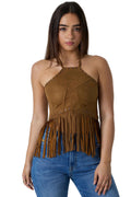 A woman modeling a brown suede halter top with fringe detailing, paired with blue jeans, against a white studio background.
