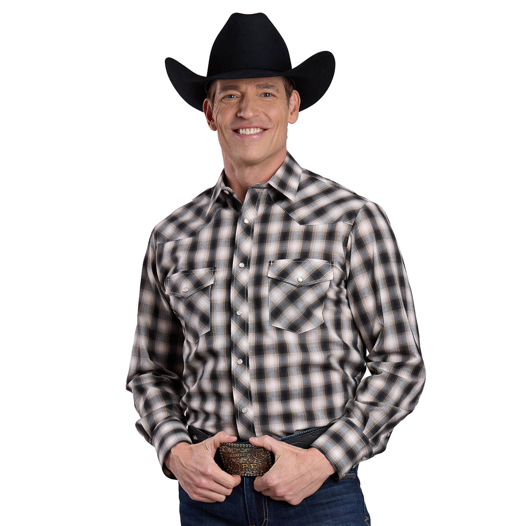 A smiling man wears a black cowboy hat, blue jeans, and the Roper Men's Karman Classic 55/45 Collection L/S Shirt (01101026) Plaid Black, holding a large belt buckle and standing against a white background.