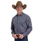 A smiling man in a Roper Mens Karman Classic 55/45 Collection L/S Shirt (01101222) Plaid Blue, blue jeans, a brown cowboy hat, and a large belt buckle stands against a white background.