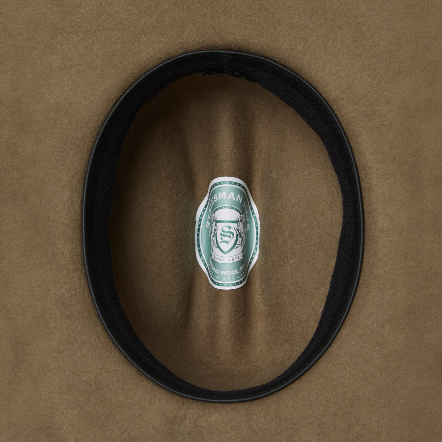 The inner of a sand Statesman Children's The Great Divide Wool Felt Cowboy Hat (21031250) with leather inner sweat band and Statesman logo.