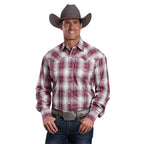 A man in a brown cowboy hat, blue jeans, large belt buckle, and a Stetson Mens Collection L/S Shirt (01478007) Plaid Red by Stetson is smiling with his hands near his waist.