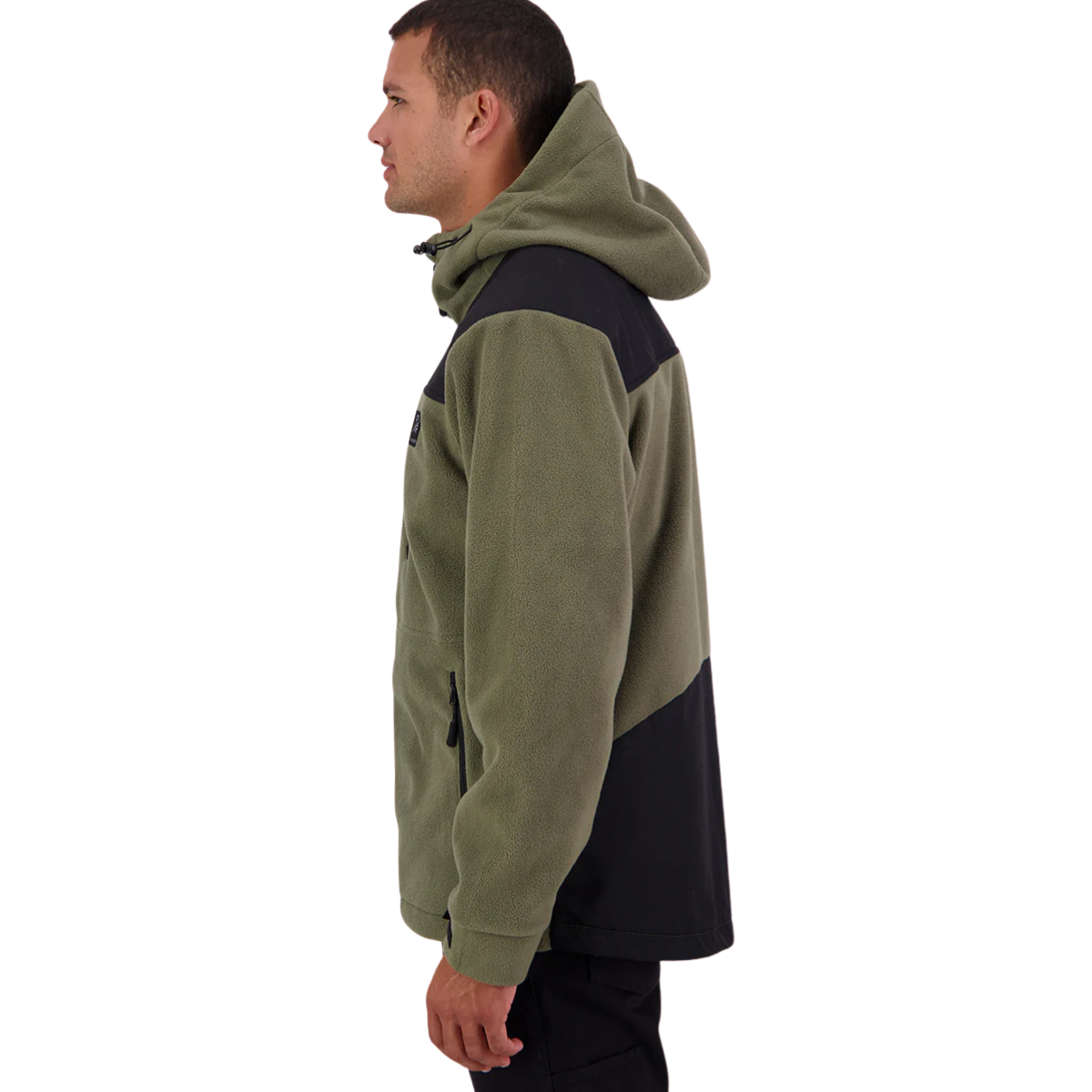 A man stands against a white background, wearing the Swanndri Men's High Rock Stormshield Jacket (SW2562070M) in Forest, an olive green weatherproof fleece with black yoke