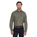 A man wearing a Thomas Cook Heavy Drill Half Button Long Sleeve Work Shirt (TCP1120163) in military green, paired with dark blue jeans and a brown belt, against a plain white background.