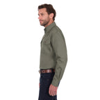 A man shown in profile wearing a Thomas Cook Heavy Drill Half Button Long Sleeve Work Shirt (TCP1120163) in military green, paired with dark blue jeans and a brown belt, against a plain white background.