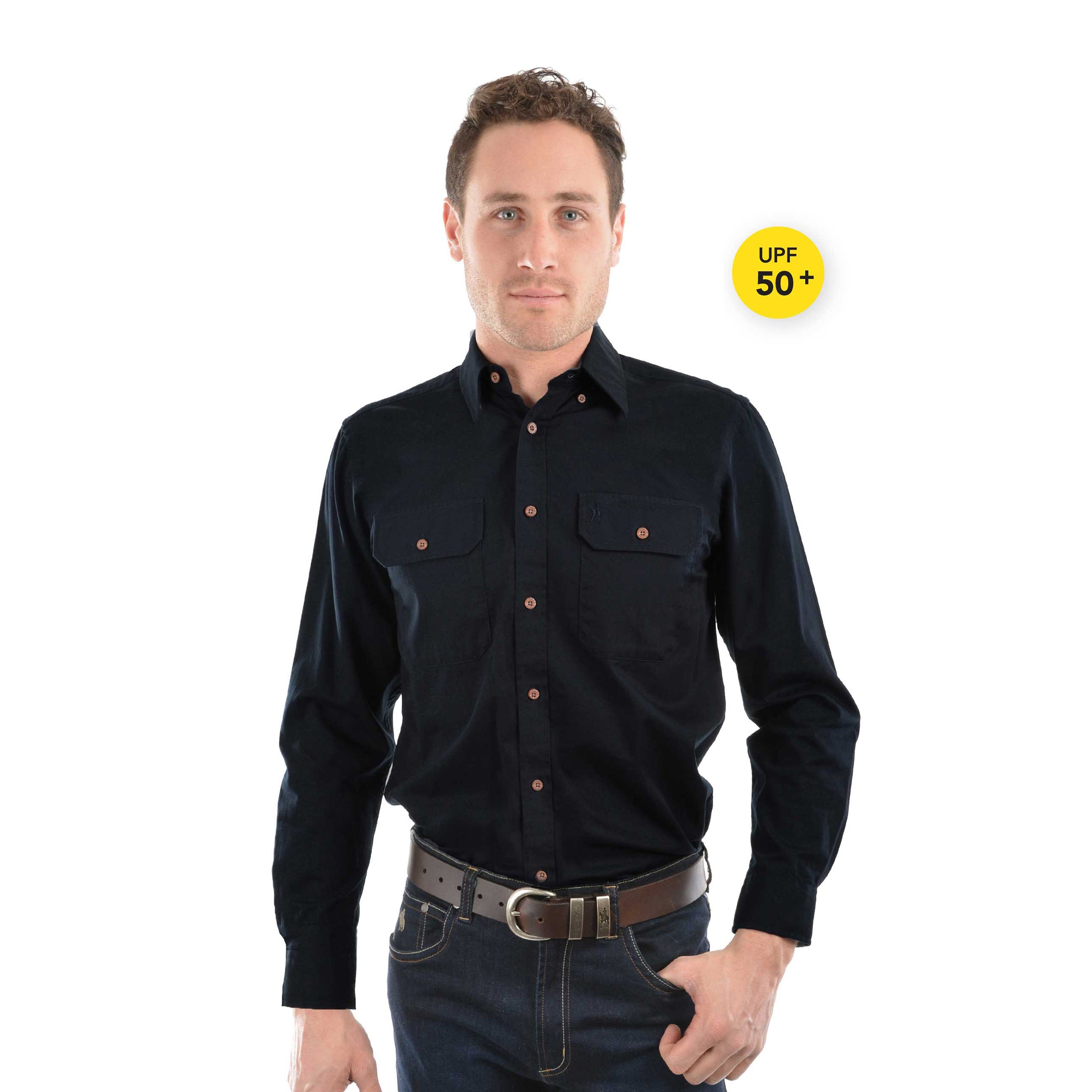 A man modelling an ink blue Thomas Cook Light Drill Full Button L/S Shirt (TCP1125005) paired with a brown leather belt and denim jeans.