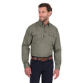 A man modelling a military green Thomas Cook Light Drill Half Button Long Sleeve Work Shirt (TCP1126005) with two chest flap pockets, paired with dark jeans and a brown belt, against a plain white background.