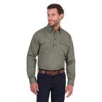 A man modelling a military green Thomas Cook Light Drill Half Button Long Sleeve Work Shirt (TCP1126005) with two chest flap pockets, paired with dark jeans and a brown belt, against a plain white background.