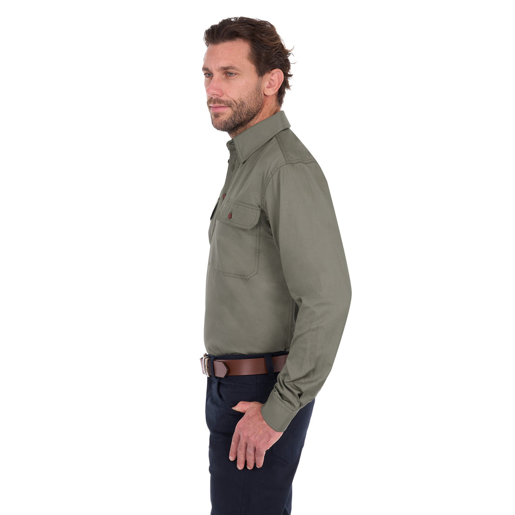A man in profile modelling a military green Thomas Cook Light Drill Half Button Long Sleeve Work Shirt (TCP1126005) with two chest flap pockets, paired with dark jeans and a brown belt, against a plain white background.