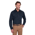 A man modelling a navy blue Thomas Cook Light Drill Half Button Long Sleeve Work Shirt (TCP1126005) with two chest flap pockets, paired with camel coloured jeans and a brown belt, against a plain white background.